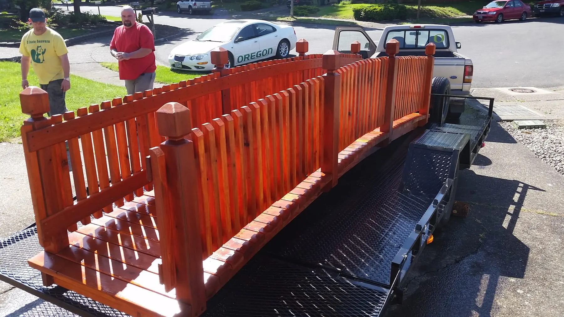 Finished red wooden fence sections loaded on a trailer for delivery